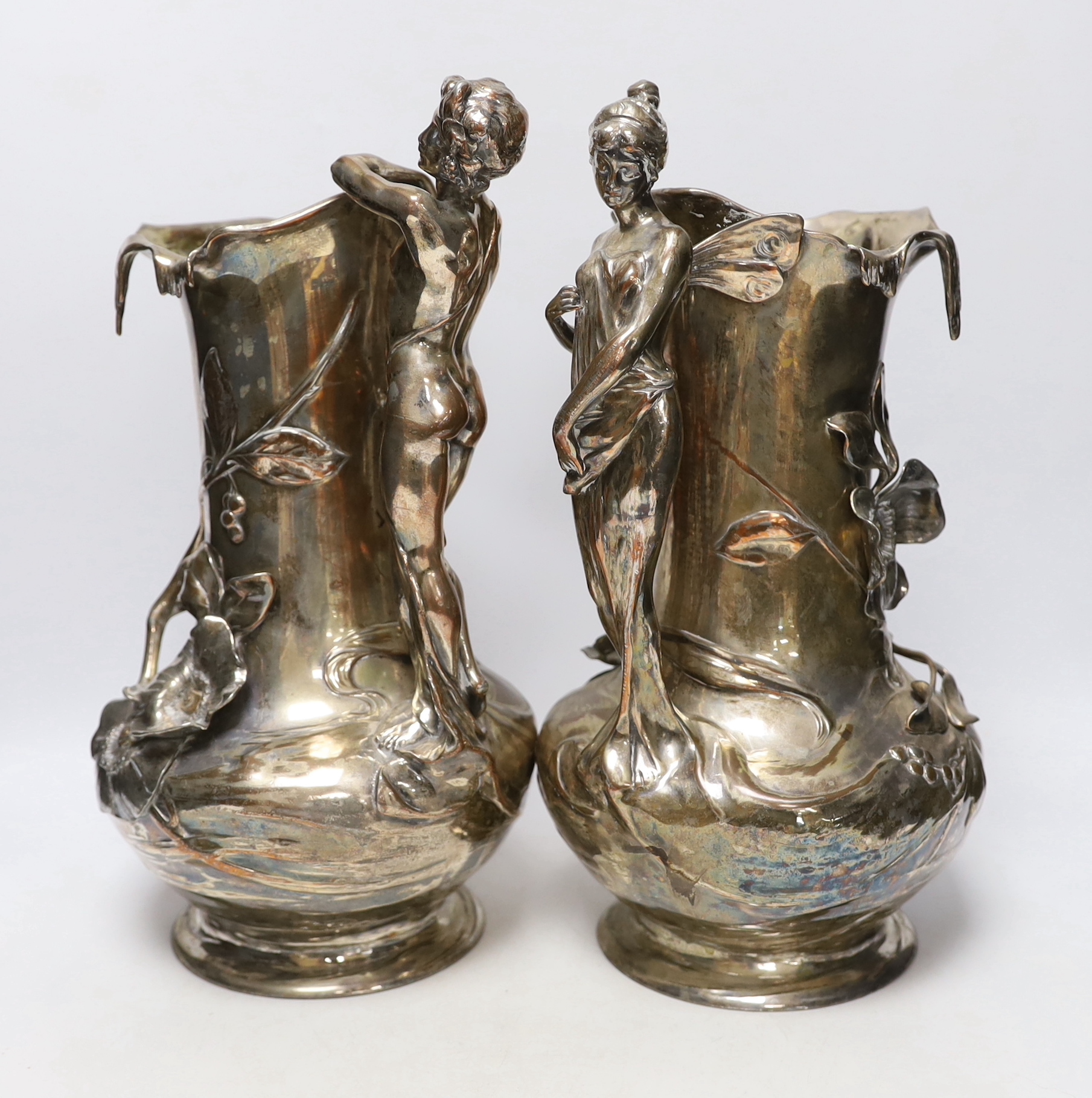 A pair of WMF Art Nouveau electroplated figural jugs and a similar mermaid jardiniere, unmarked, largest 35cm high